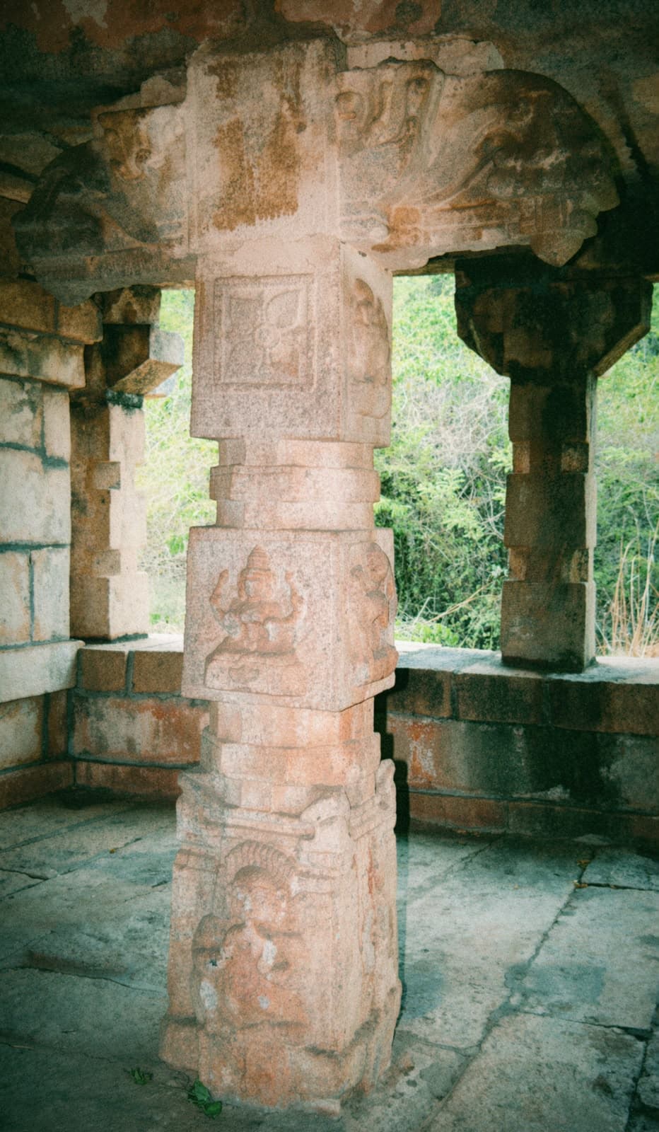 Carved stone columns supporting a stone roof.